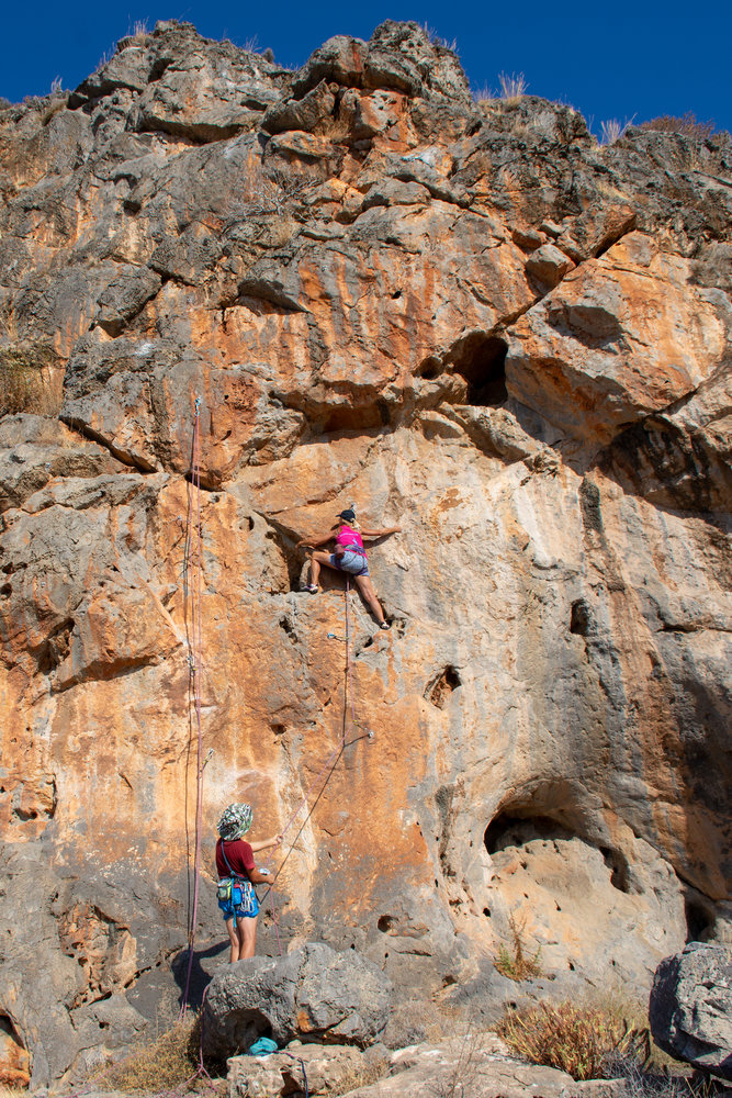 Person rock climbing at Krinakia beach, Xerokampos, east Crete